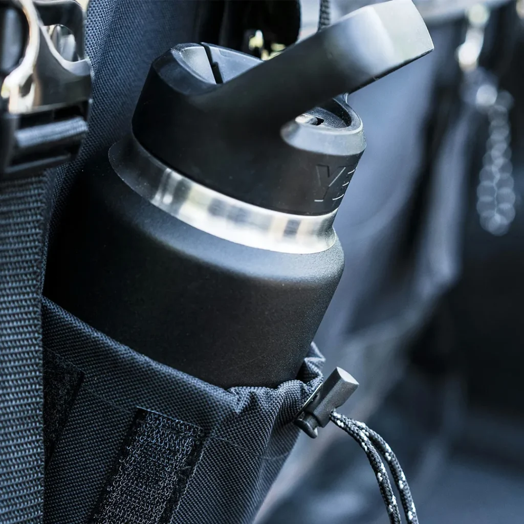 Reusable black water bottle stored in a conference bag, representing practical branded merchandise for events.