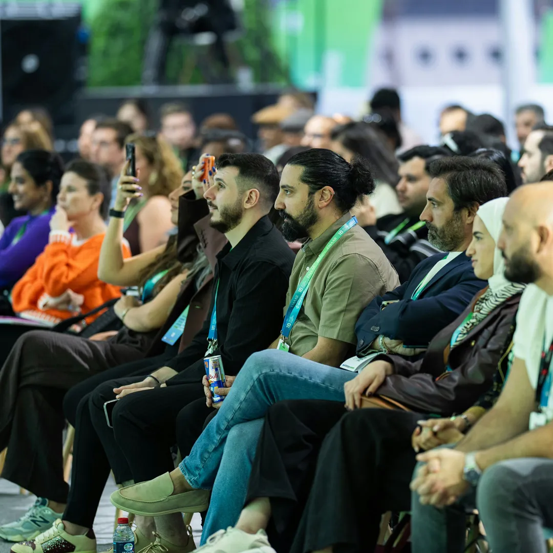 Conference attendees engaged in a keynote presentation at a large-scale business event designed to enhance audience experience and engagement.